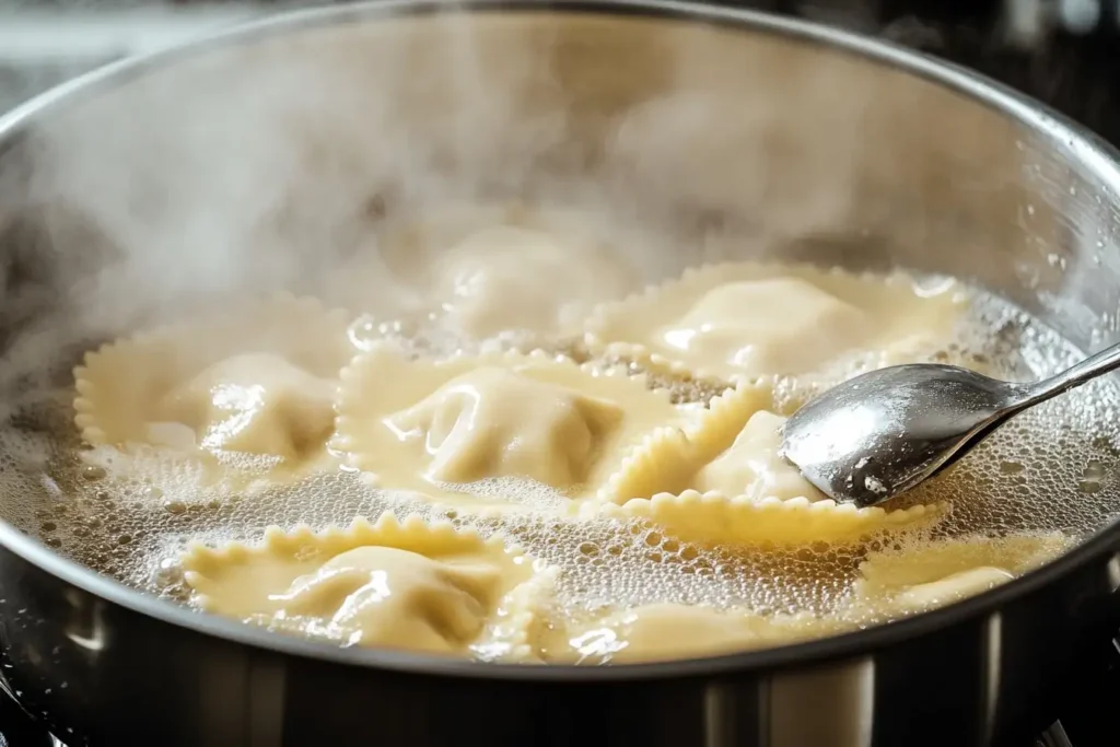 Spinach ravioli boiling in a stainless steel pot, with steam rising and a slotted spoon ready to scoop the ravioli.