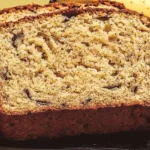 lose-up of moist and fluffy banana bread slices showing texture and banana specks.